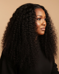 Woman with long, curly black hair against a beige background