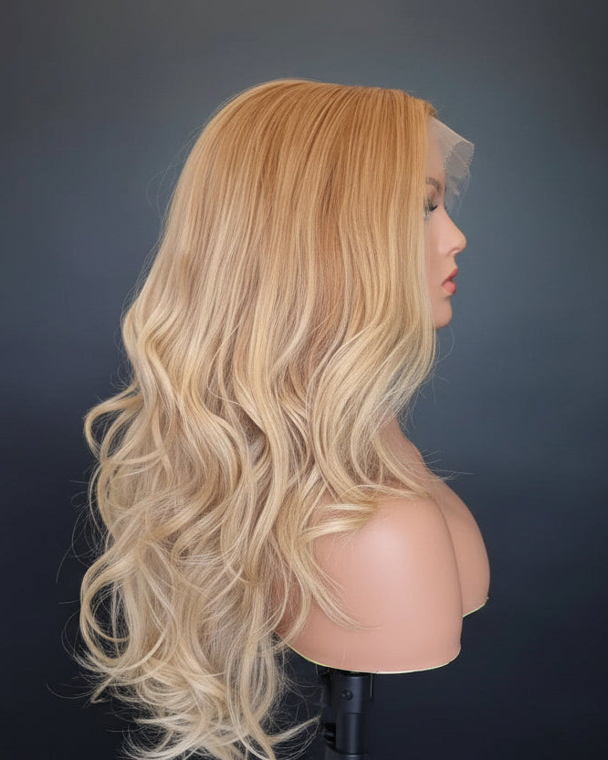 Blonde wig on a mannequin head against a black background