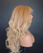 Blonde wig on a mannequin head against a black background