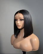Mannequin head with a black straight wig on a gray background