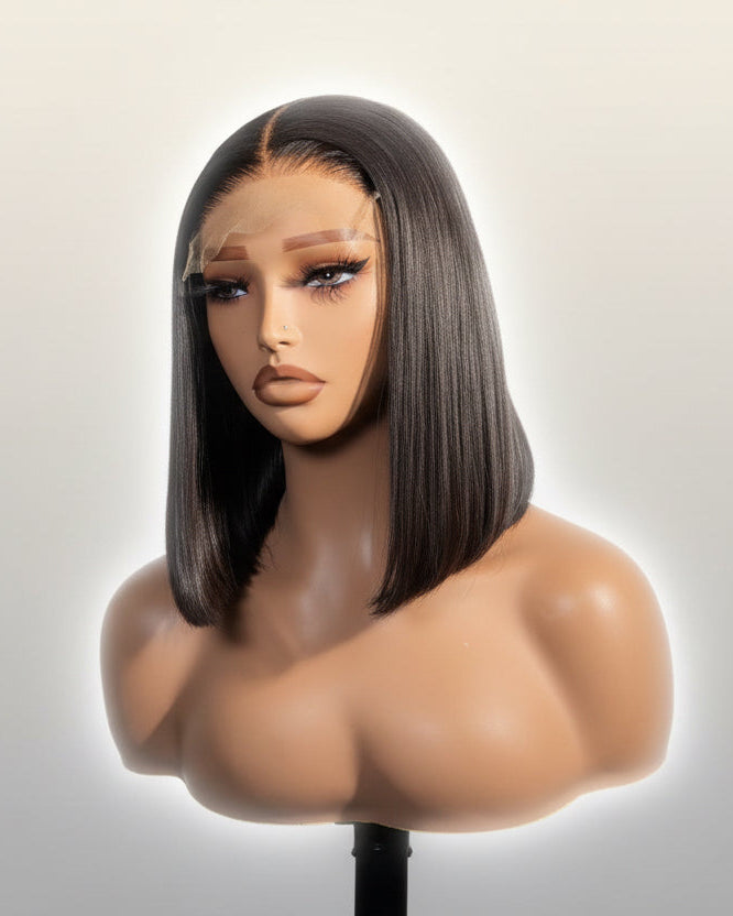 Mannequin head with a straight brown wig on a neutral background