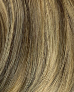 Close-up of brown and blonde hair extensions on a white background