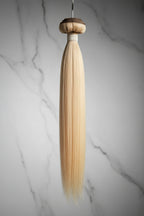 Blonde 613 Vietnamese raw hair extensions wefted bundle on a white background