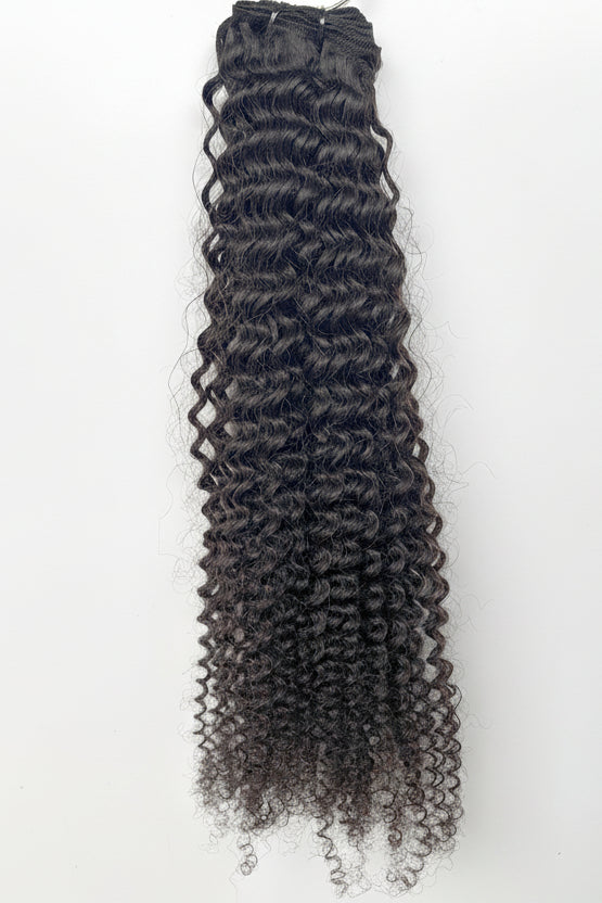 Black curly Vietnamese raw hair extensions on a white background