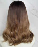 Brown hair extensions on a white surface