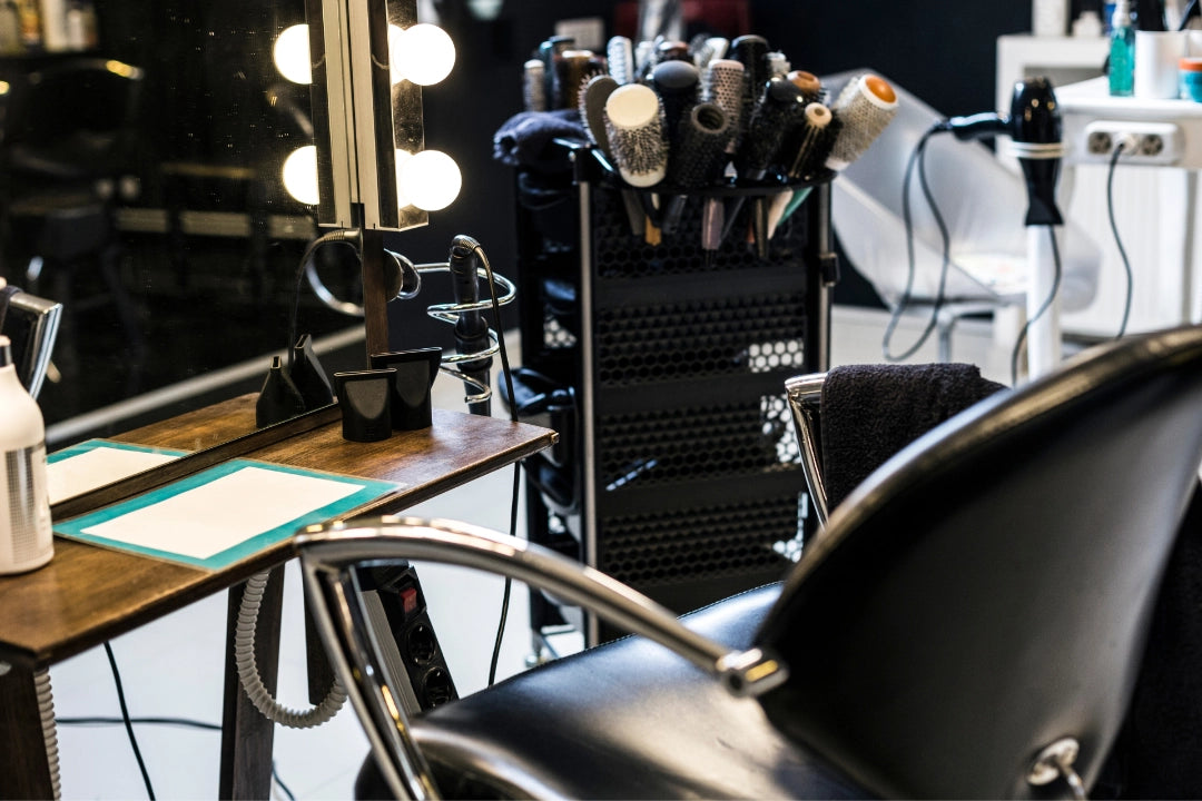 Salon chair with styling tools and equipment in a salon setting