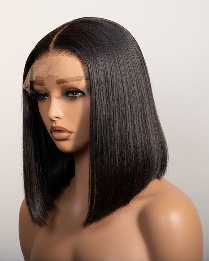 A mannequin head with a black straight Vietnamese raw hair wig on a plain background