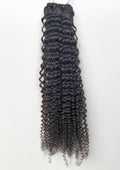 Black curly hair extensions on a white background