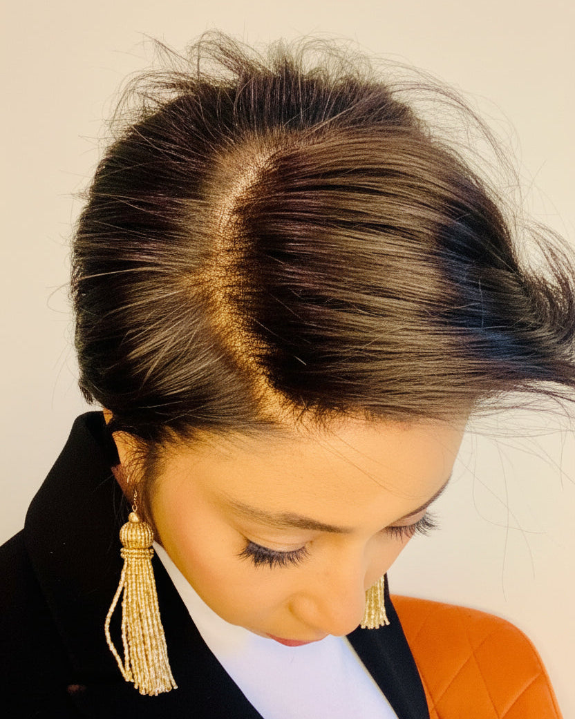 Flawless, undetectable full-lace parting for a natural scalp illusion on a woman in a white shirt and black blazer looking down.