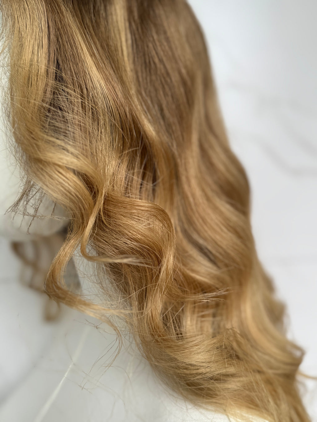 Blonde hair with wavy texture on a white background
