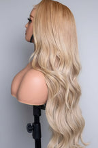 Blonde wig made with Vietnamese single-donor raw hair bundles on a mannequin head against a plain background